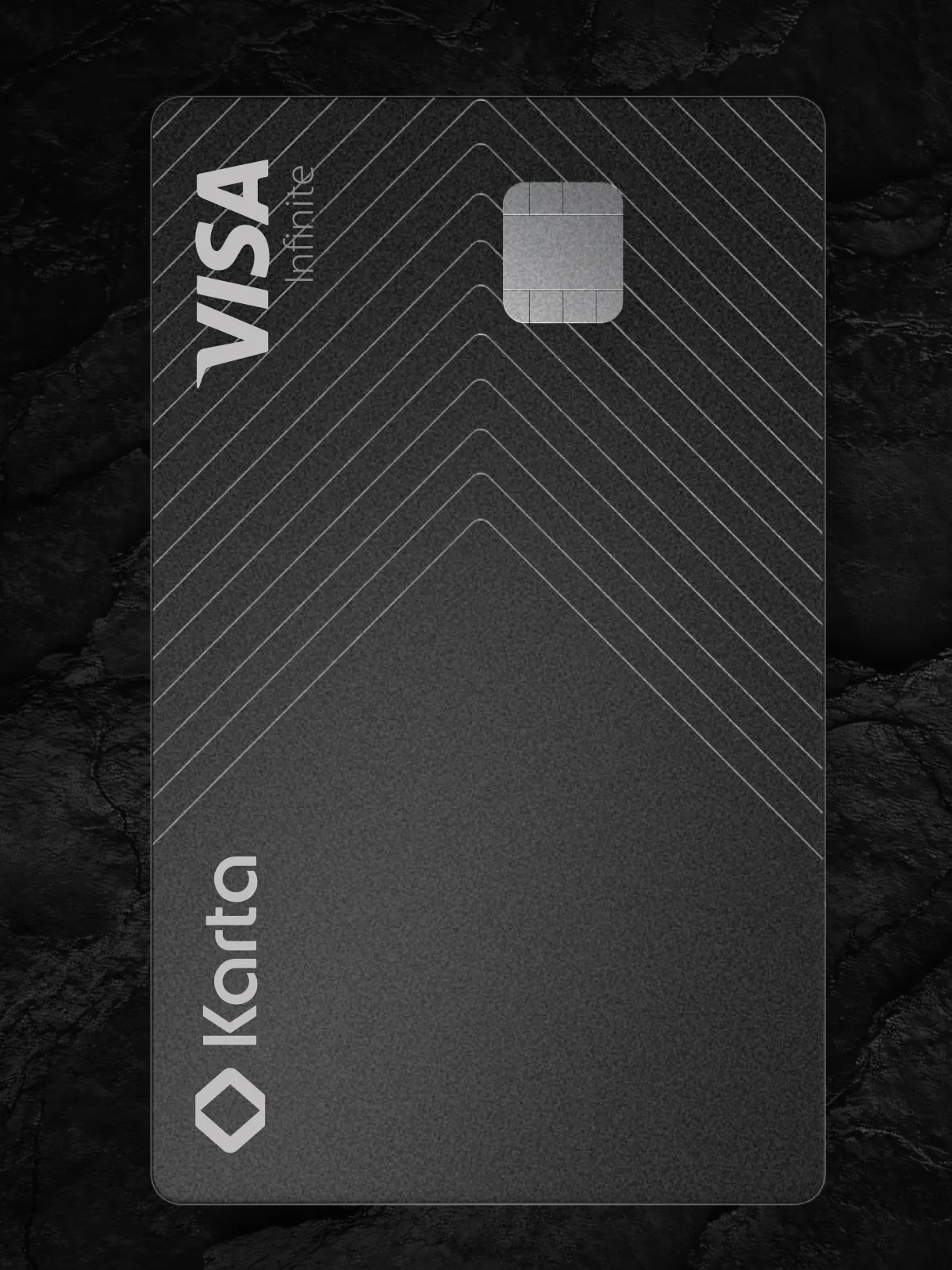 Karta Card final product in portrait — black heavyweight premium credit card with the Karta wordmark etched vertically, engraved chevron line pattern, EMV chip and VISA Infinite branding on a textured matte-noir surface, the 17-gram metal design Comandos shipped that gained 1,000 LATAM high-net-worth customers in the first 12 months