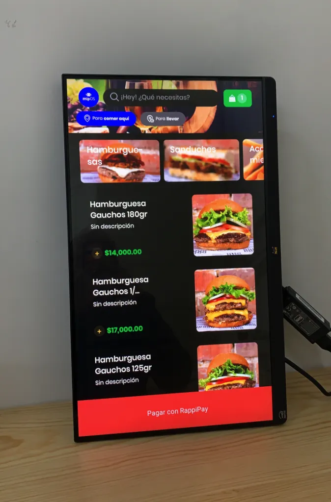 mipOS Kiosk redesigned Chili's self-order screen on a ROKU-native device — colourful floating burgers, fries and tacos around the Chili's logo, tuned for any touch device
