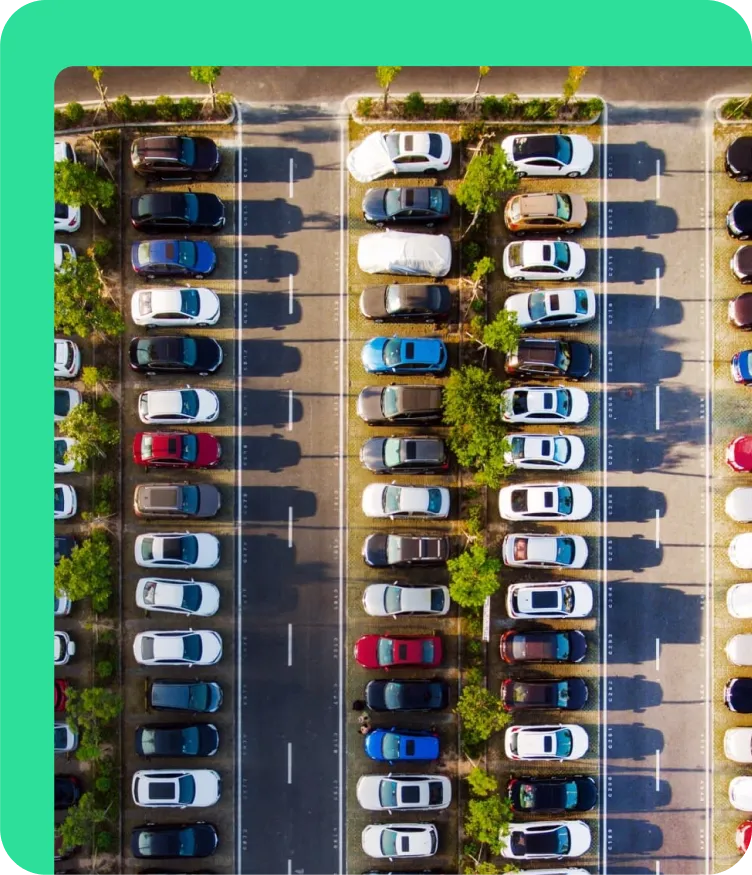 Aerial view of a Puerto Rico shopping-mall parking lot with dozens of cars across multiple lanes — the high-density, tourist-heavy context where 76% of citizens own a vehicle and where Spotfinder had to solve the 1-hour parking search